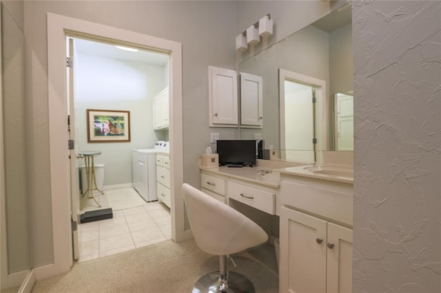 bathroom featuring tile patterned floors, vanity, and independent washer and dryer