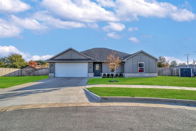 ranch-style home featuring a garage and a front lawn