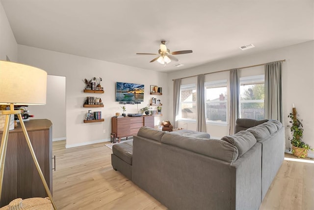 living room featuring light wood-type flooring and ceiling fan