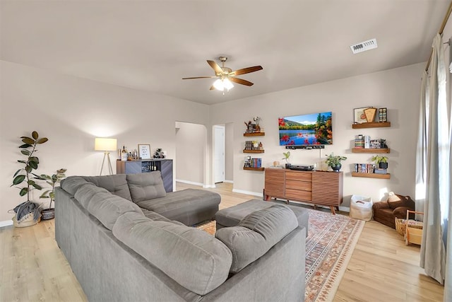 living room featuring ceiling fan and light hardwood / wood-style flooring