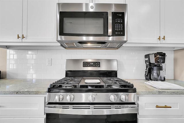 kitchen featuring backsplash, white cabinets, and appliances with stainless steel finishes