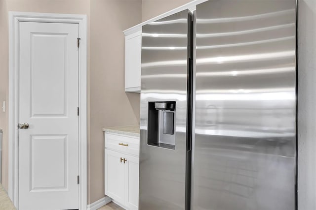 kitchen with white cabinets and stainless steel fridge with ice dispenser