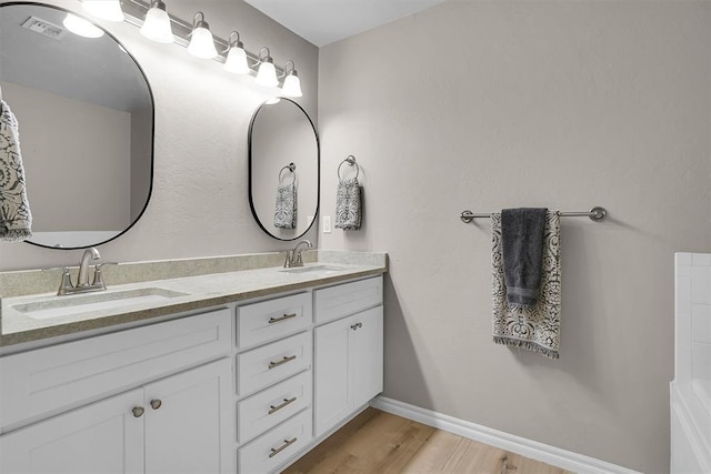 bathroom featuring wood-type flooring and vanity