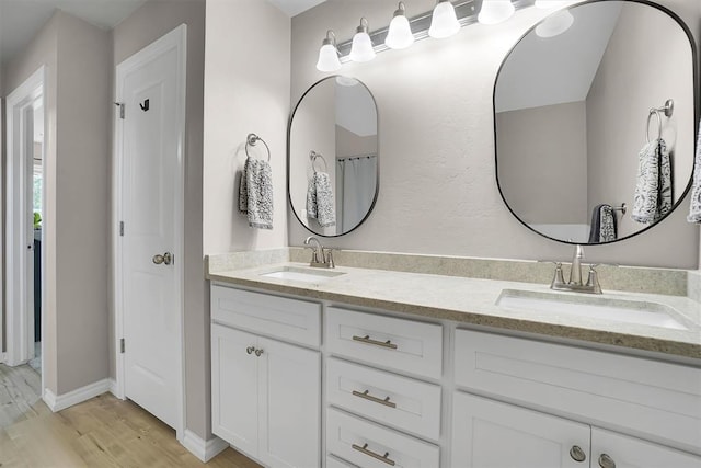 bathroom with vanity and wood-type flooring