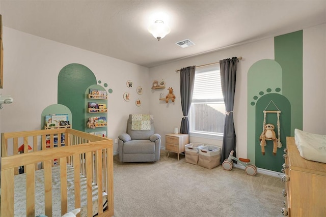 bedroom featuring carpet flooring and a crib