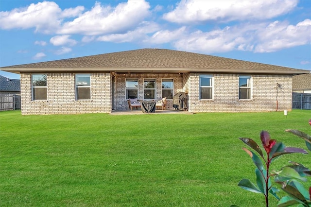 back of house featuring a patio and a lawn