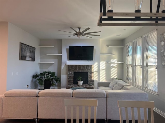 living room featuring ceiling fan, wood-type flooring, and a fireplace