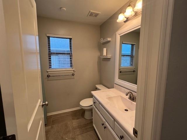 bathroom with vanity and toilet