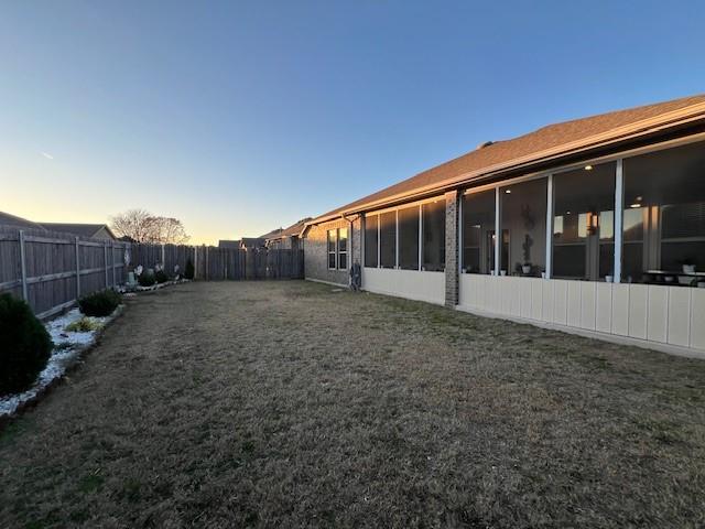 view of yard at dusk