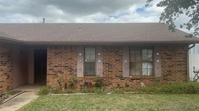 view of exterior entry featuring a lawn