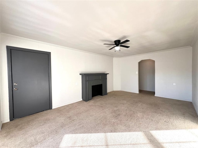 unfurnished living room with light colored carpet, ceiling fan, and ornamental molding