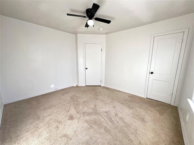 empty room with carpet flooring and ceiling fan