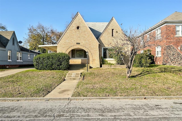 tudor home with a front yard