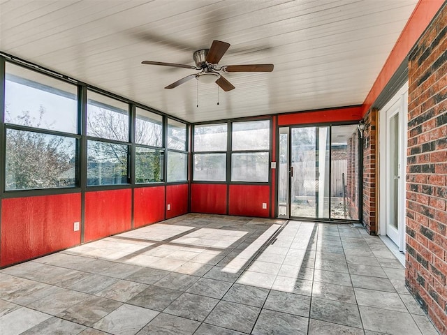 unfurnished sunroom with ceiling fan and a healthy amount of sunlight