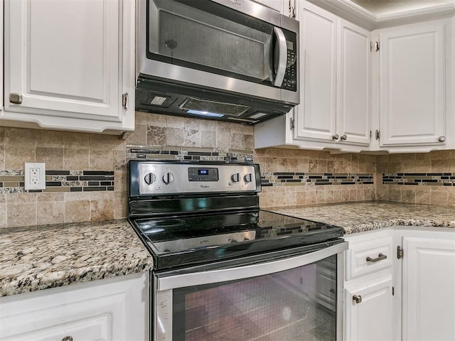 kitchen featuring white cabinets, backsplash, and stainless steel appliances