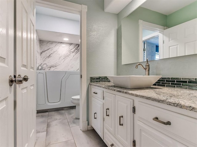 bathroom featuring tile patterned flooring, vanity, and toilet