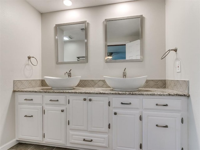 bathroom featuring tile patterned floors, vanity, and decorative backsplash