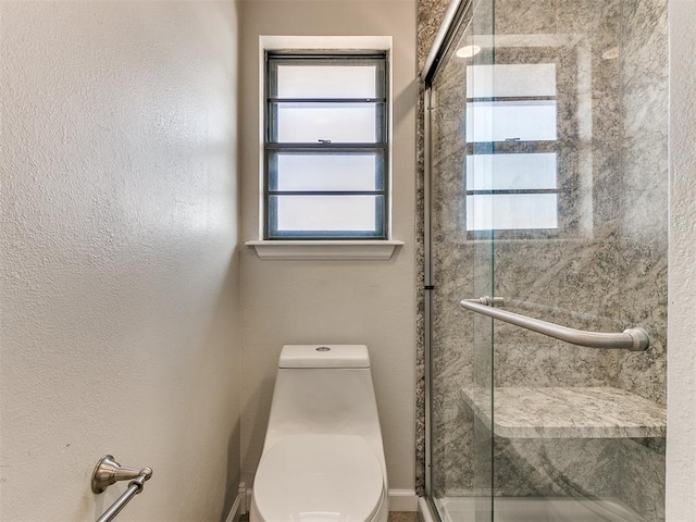 bathroom with walk in shower and toilet