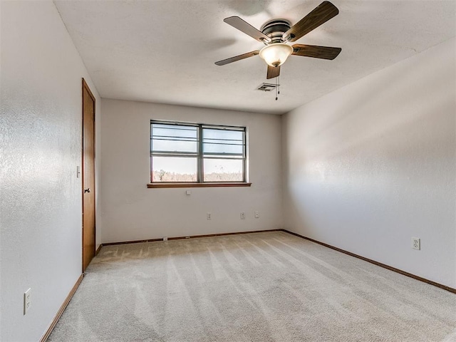 unfurnished room with ceiling fan and light colored carpet