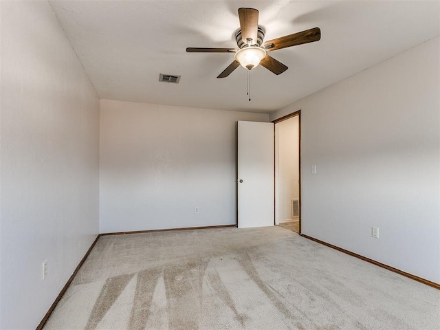 empty room featuring light colored carpet and ceiling fan