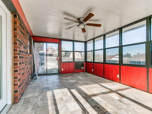 unfurnished sunroom with plenty of natural light and ceiling fan