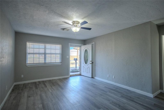 entryway featuring a textured ceiling, dark hardwood / wood-style floors, and ceiling fan