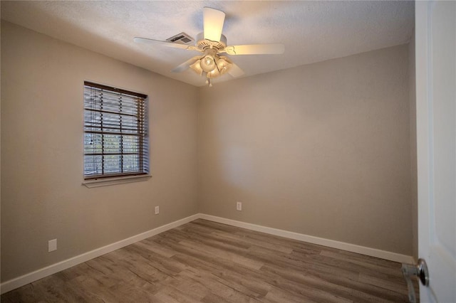 empty room with wood-type flooring, a textured ceiling, and ceiling fan