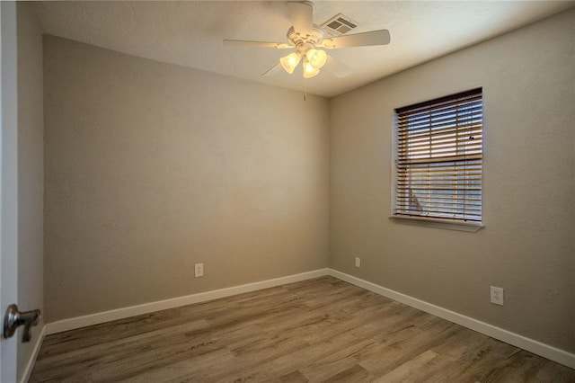 unfurnished room with hardwood / wood-style floors and ceiling fan