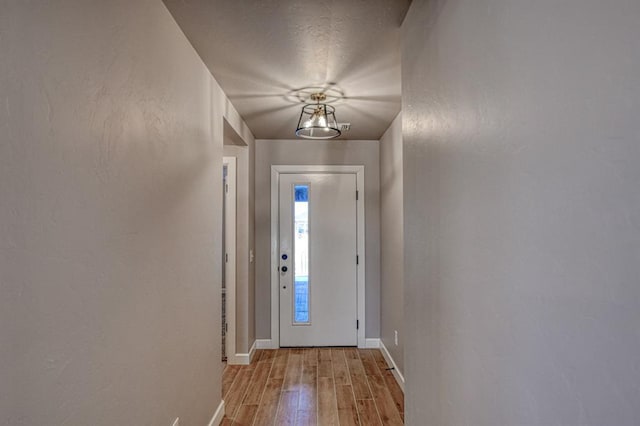 doorway with a chandelier