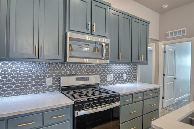 kitchen featuring ceiling fan, backsplash, and appliances with stainless steel finishes