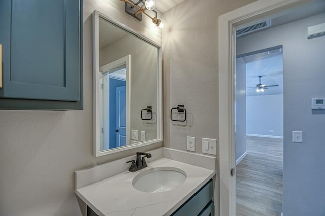 bathroom with ceiling fan, hardwood / wood-style floors, and vanity