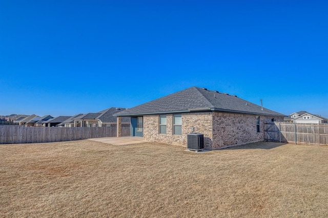 back of house featuring a yard, a patio area, and central AC unit