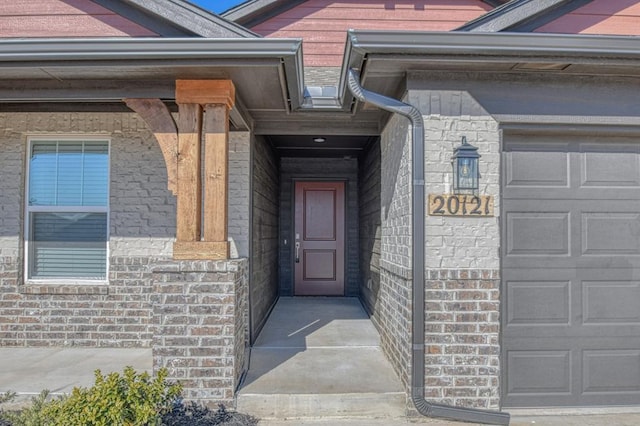 view of exterior entry with a garage