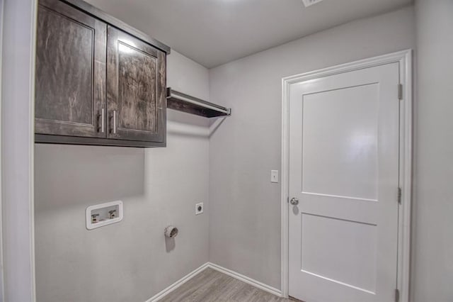 laundry room with cabinets, washer hookup, light hardwood / wood-style flooring, and electric dryer hookup