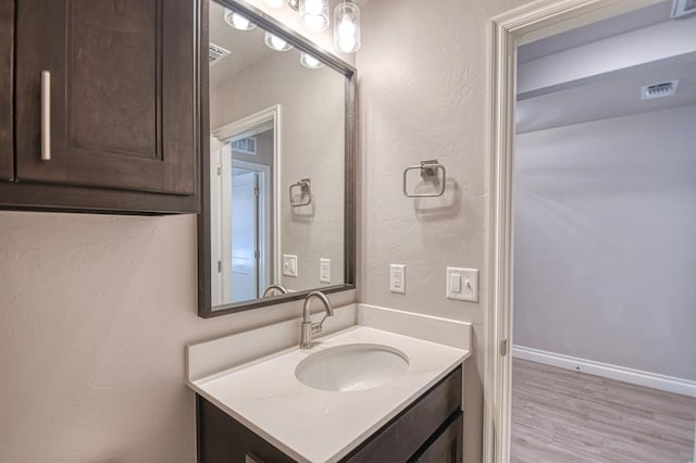 bathroom with vanity and hardwood / wood-style floors