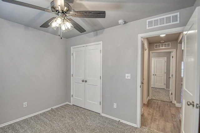 unfurnished bedroom with ceiling fan, carpet floors, and a closet