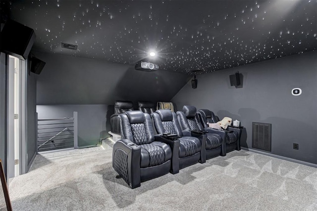 carpeted cinema featuring vaulted ceiling