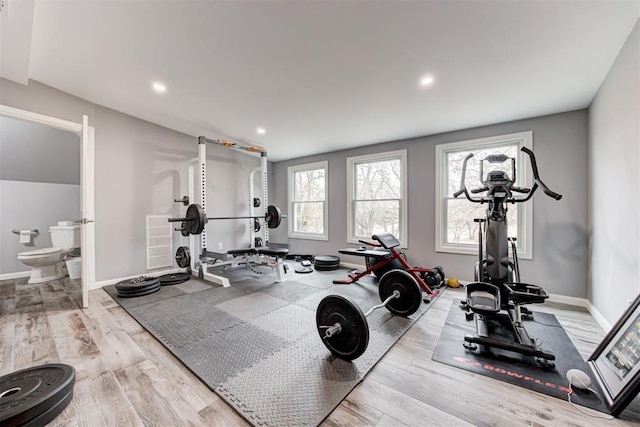 workout room with light hardwood / wood-style flooring