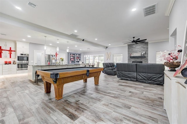 rec room with ceiling fan, light wood-type flooring, ornamental molding, pool table, and beamed ceiling