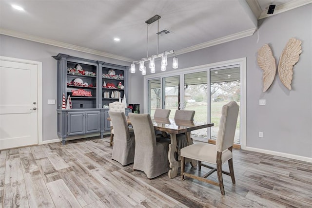 dining space with light hardwood / wood-style flooring and ornamental molding