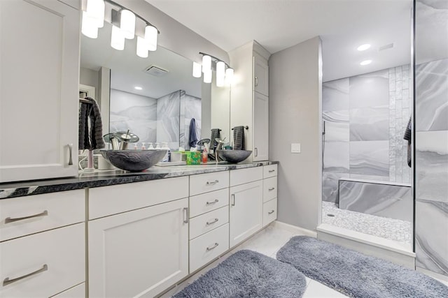 bathroom featuring vanity and a tile shower