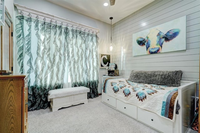 bedroom with wood walls and carpet