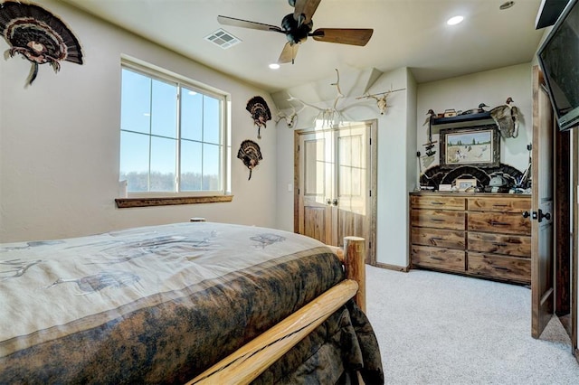 bedroom with ceiling fan and light colored carpet