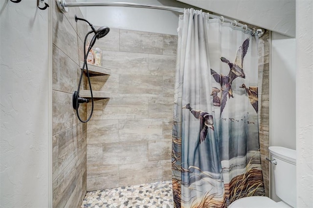 bathroom featuring curtained shower and toilet