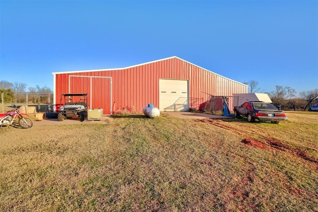 view of outdoor structure featuring a yard and a garage