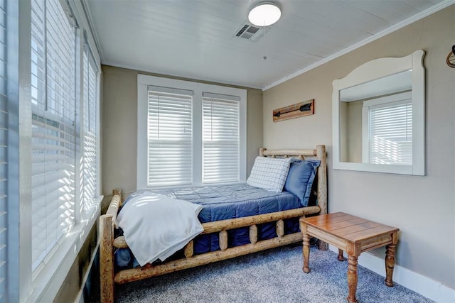 carpeted bedroom featuring ornamental molding and multiple windows