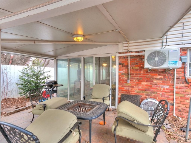 view of patio with area for grilling, a fire pit, and ac unit