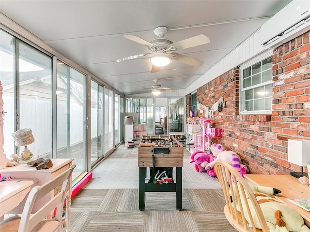 sunroom with ceiling fan, plenty of natural light, and a wall mounted AC