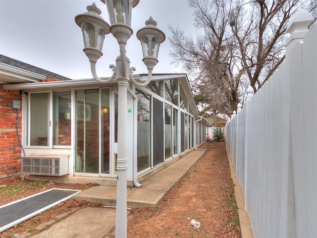 view of side of home with a sunroom