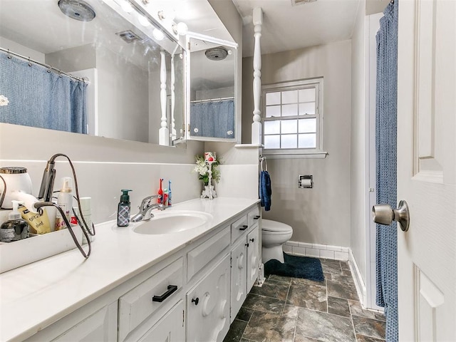 bathroom featuring toilet and vanity